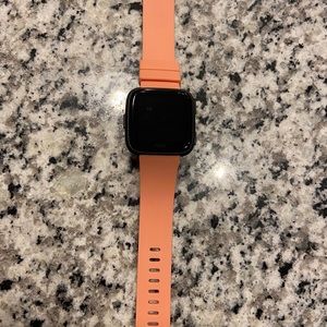 Fitbit Versa smartwatch with charger and band